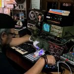Kamal Sabran jams in the studio with his cat