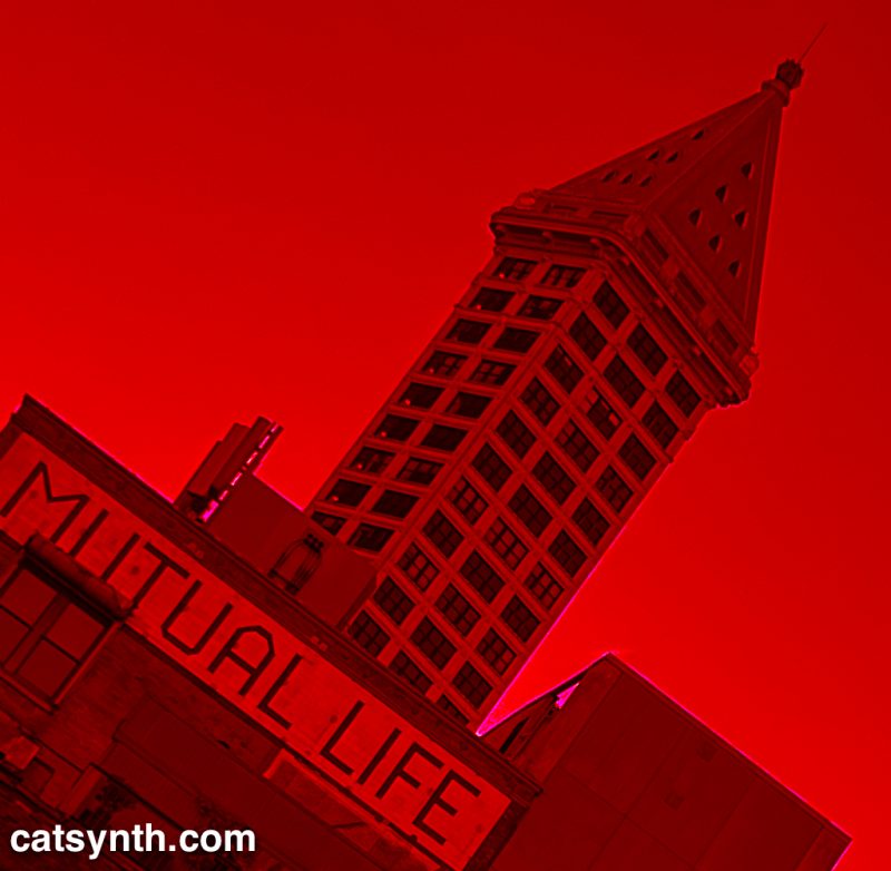 Smith Tower, behind Mutual Life building in Seattle.  Tilted to the side and colored only in shades of red.